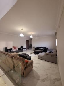 a living room with two couches and a table at Villa Casablanca in 6th Of October