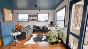 a living room with a couch and a table at Pristine Patagonia Hotel in Puerto Natales