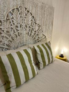 a bedroom with a bed with a large headboard at Pátio dos 8 - Alentejo in Vale de Santiago