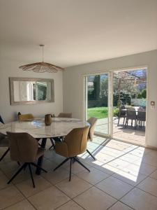 a dining room with a table and chairs and a patio at Villa dolce vita in Nans-les-Pins