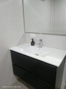 a bathroom with a white sink and a mirror at Room cerca al aeropuerto #2 in Bogotá