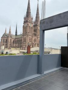 a view of a large building with a clock tower at Casa Olivia in Luján +6 photos