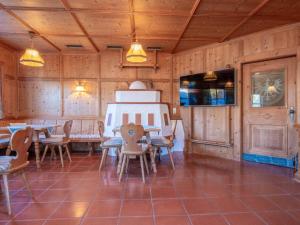 a dining room with wooden walls and tables and chairs at Pension Blaiken M in Scheffau am Wilden Kaiser +30 photos