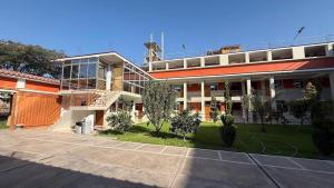 a large building with a staircase in front of it at Hostal Bon in Nazca