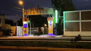 a gazebo in front of a building at night at Hostal Bon in Nazca +1 photo