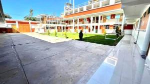 an empty courtyard of a school building at Hostal Bon in Nazca
