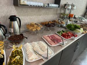 a buffet with different types of food on a counter at Empire Hotel Baku F1 view in Baku