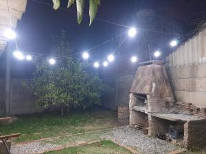 a stone oven in a backyard at night with lights at El Viejo Nogal in Gómez