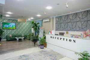 a reception area of a store with green furniture at Empire Hotel Baku F1 view in Baku