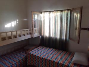 a small bedroom with a bed and a window at El Viejo Nogal in Gómez