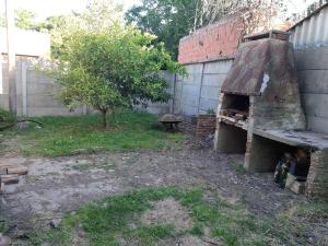 a brick oven in a yard next to a building at El Viejo Nogal in Gómez +1 photo