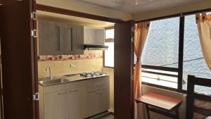 a small kitchen with a sink and a window at Hotel Rocamonti in Aquitania