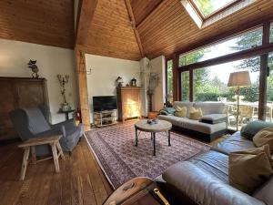 a living room with a couch and a table at Boogie House in Rendeux