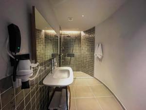 a small bathroom with a sink and a mirror at Blue Inn Hotel in Gökçeada +26 photos