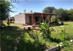 a small house in the middle of a yard at Finca El Legado in Santa Rosa