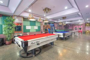 a billiard room with two pool tables in it at Grand Leo Hotel in Khon Kaen