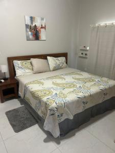 a bedroom with a bed with a blanket on it at B's Hidden Paradise in Philipsburg
