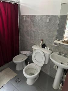 a bathroom with a toilet and a sink at Mica in Salta
