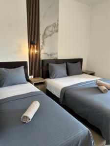two beds sitting next to each other in a room at STANDART Premium in Ulcinj