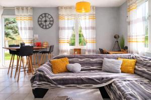 a living room with a couch and a table at La Ptite Maison Gîte Alsace à la campagne in Sickert