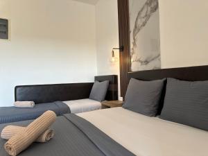 a hotel room with two beds and a couch at STANDART Premium in Ulcinj