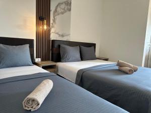 two beds sitting next to each other in a room at STANDART Premium in Ulcinj +55 photos