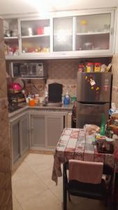 a kitchen with a table and a refrigerator at ma chambre in Casablanca
