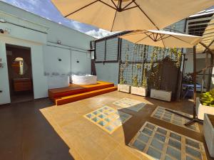 a patio with two umbrellas on top of a building at Apartaestudios Zeni in Medellín