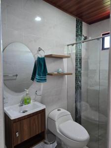 a bathroom with a toilet and a sink and a shower at Finca La Tranquilidad in San Francisco
