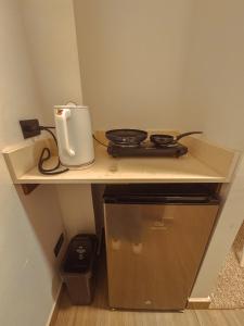 a counter top with a stove and a appliance on it at Apartaestudios Zeni in Medellín