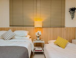 two beds sitting next to each other in a bedroom at Hongdae 10 min Family 2BR Direct Airport Bus from ICN airport in Seoul +33 photos