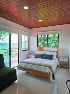 a bedroom with a large bed with a wooden ceiling at Finca La Tranquilidad in San Francisco
