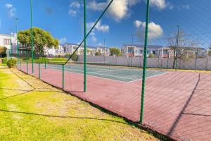 a tennis court with two tennis courts at 3 bed Cluster home in Sandton in Sandton