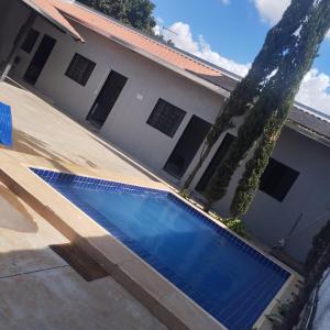 a swimming pool in front of a house at Espaço Atlântico in Goiânia