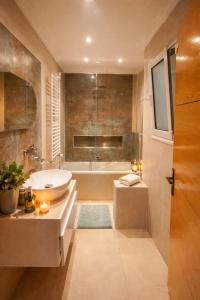 a bathroom with a tub and a sink at Dar Al Yaqout in Le Kram +11 photos
