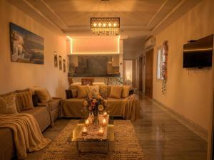 a living room with a couch and a table at Dar Al Yaqout in Le Kram