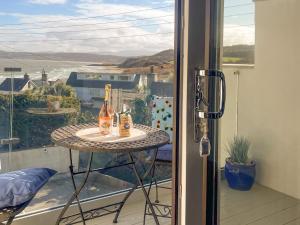 a table with two bottles of champagne on a balcony at The Holiday House in Benllech