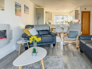 a living room with a couch and a table at The Holiday House in Benllech