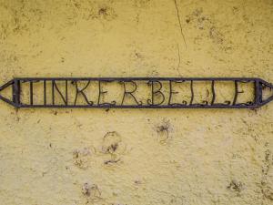 an iron sign on a wall with the word invincible at Tinkerbell in Balnaboth