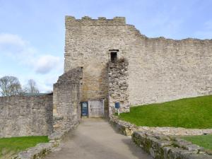 a large stone building with a door in it at Pear Tree Farm Cottages - Rchm38 in Ebberston