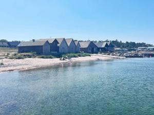 a group of houses on the shore of a body of water at 4 star holiday home in Klintehamn in Klintehamn