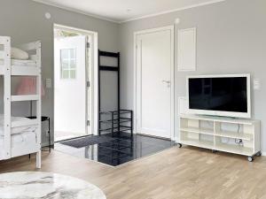 a living room with a flat screen tv on a dresser at 4 star holiday home in Klintehamn in Klintehamn