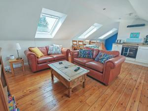 a living room with two couches and a coffee table at Stonechat Barn in Pancrasweek