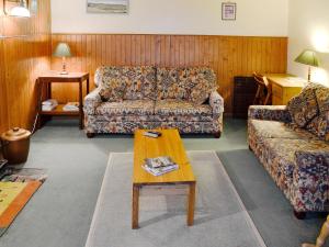 a living room with two couches and a coffee table at Buckhood - Swwy in Inchmill