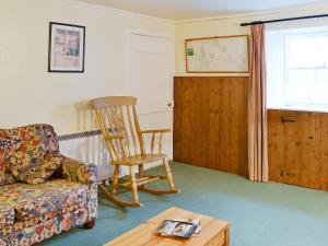 a living room with a rocking chair and a coffee table at Buckhood - Swwy in Inchmill