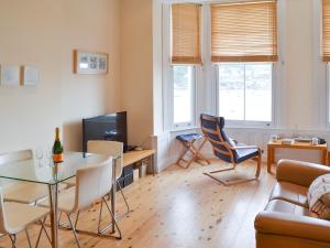 a living room with a table and chairs and a couch at Tides Reach in Fowey