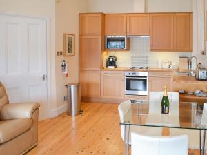 a kitchen with a glass table in a room at Tides Reach in Fowey