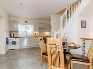 a kitchen and dining room with a table and chairs at The Bothy in Mathon