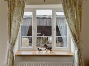 two toy horses sitting on a window sill at Bess's Cottage in Middlewich +2 photos