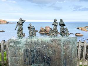 a group of people statue sitting on top of a fountain at Fairlaw Garden Cottage in Reston